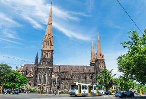 A church with a train on the street Description automatically generated with medium confidence