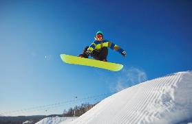 A person jumping on a snowboard Description automatically generated