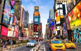 A city street with many buildings and cars
Description automatically generated