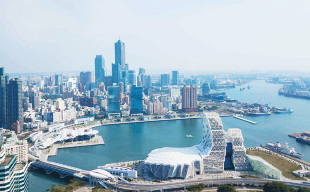 A city with a body of water and a bridge
Description automatically generated