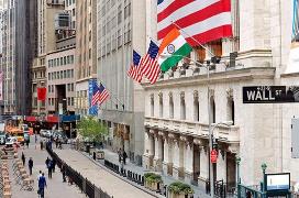 A street with flags on the side of a building
Description automatically generated