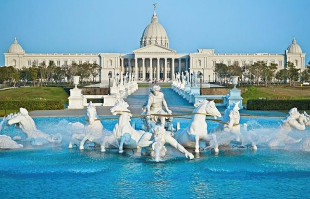 A white building with a large fountain with horses
AI-generated content may be incorrect.