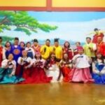 A group of people in traditional clothing AI-generated content may be incorrect.