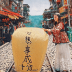 A person standing on train tracks with a large yellow lantern AI-generated content may be incorrect.