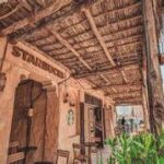 A building with a thatched roof Description automatically generated