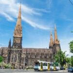 A church with a train on the street Description automatically generated with medium confidence