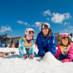 A group of people sitting in the snow Description automatically generated