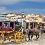 A horse drawn carriage with horses Description automatically generated