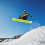 A person jumping on a snowboard Description automatically generated