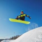 A person jumping on a snowboard Description automatically generated