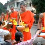 A group of people in orange robes Description automatically generated