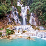A waterfall in the forest Description automatically generated