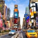 A city street with many buildings and cars Description automatically generated