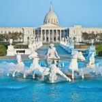 A white building with a large fountain with horses AI-generated content may be incorrect.