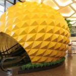 A yellow sphere shaped object in a building AI-generated content may be incorrect.